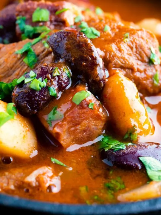 Close up Hungarian bean goulash or babgulyas served in an iron bowl.