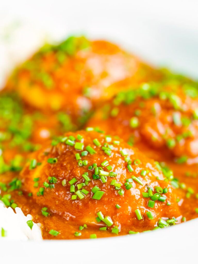 Boiled egg curry or anda masala served with snipped chives.
