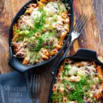 Individual meatball pasta bake with a cheesy topping served in stoneware bowls featuring a title overlay.