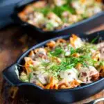 Cheesy meatball pasta bake served in individual stoneware bowls.