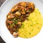 Overhead vegan mushroom ragu served with polenta and a parsley garnish
