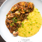 Overhead vegan mushroom ragu served with polenta and a parsley garnish featuring a title overlay