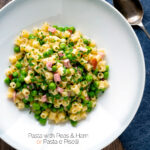 Pasta e piselli or pasta with peas and ham served in a white bowl featuring a title overlay.