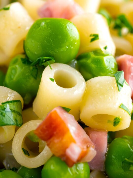 Close up pasta e piselli or pasta with peas and ham.