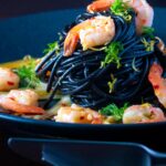 Prawn pasta with squid ink spaghetti fennel, lime zest and chilli.