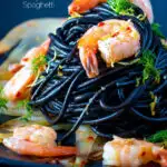 Prawn pasta with squid ink spaghetti fennel, lemon zest and chilli featuring a title overlay.