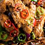 Salt and chilli chicken served with peppers and onion on soy sauce noodles.