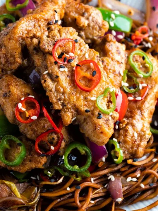 Salt and chilli chicken served with peppers and onion on soy sauce noodles.
