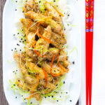 Overhead crispy Chinese salt and pepper chicken with pickled daikon featuring a title overlay.