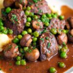 Chicken liver stew with button mushrooms and peas in a red wine sauce.