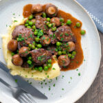 Chicken liver stew with button mushrooms and peas in red wine sauce served with mashed potato featuring a title overlay.