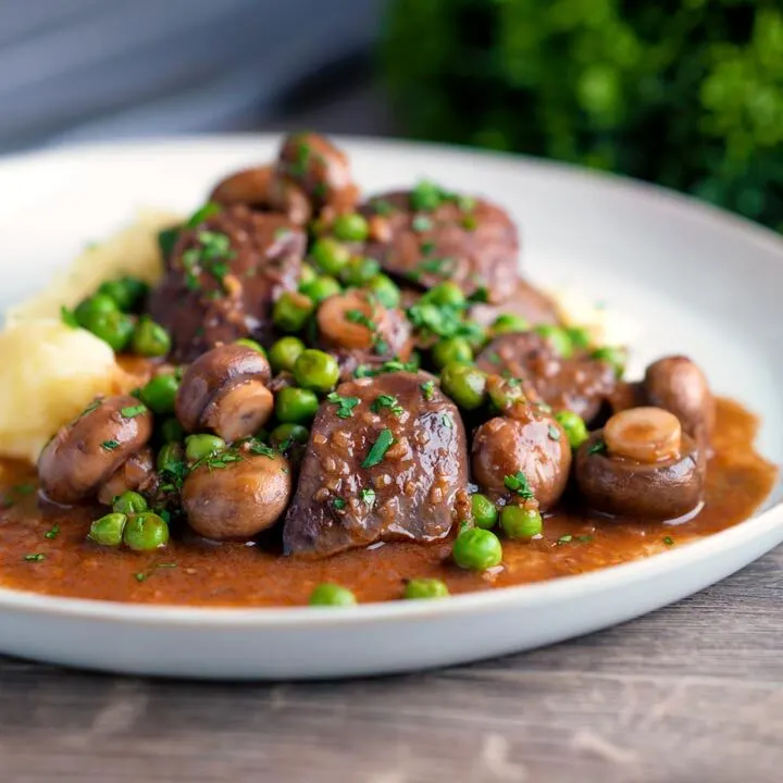 Simple Chicken liver stew with button mushrooms and peas in red wine sauce & mashed potato.