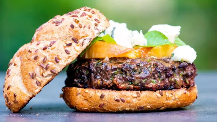 Venison burger topped with blue cheese, gin cooked peaches & basil.