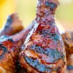 Close up bbq chicken drumsticks with a beer, paprika and honey glaze.