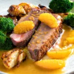 Pan fried duck breast with orange sauce served with roast potatoes & broccoli.