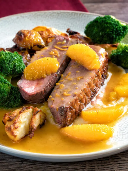 Pan fried duck breast with orange sauce served with roast potatoes & broccoli.