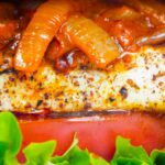 Close up Halloumi burger with harissa onions, tomato & lettuce.