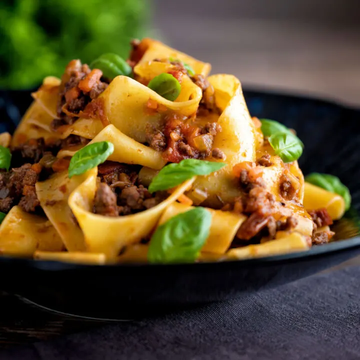 Minced lamb ragu with pappardelle pasta and fresh basil.