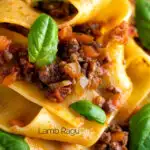 Close up lamb ragu with pappardelle pasta and fresh basil featuring a title overlay.