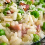 Close up pea and ham risotto served in a blue bowl.