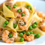 Prawn and pea pasta with pappardelle and shredded basil.