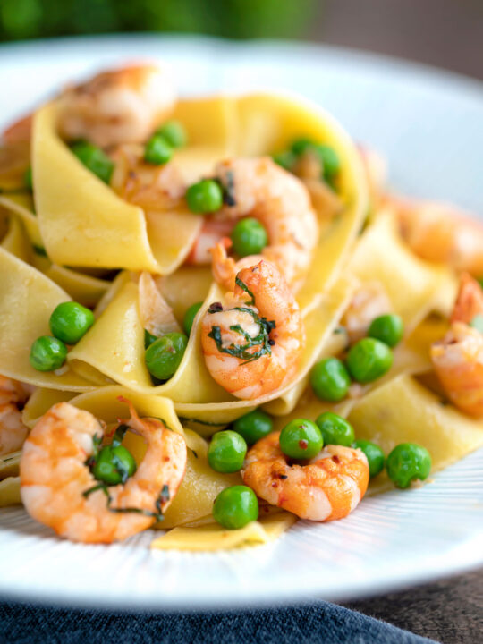 Prawn and pea pasta with pappardelle and shredded basil.