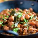 Vegan Punjabi chole masala curry or chana masala served in an iron karai.