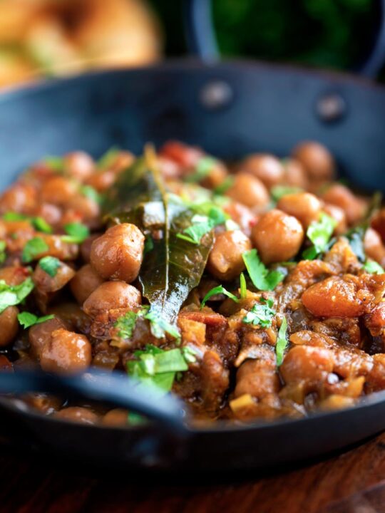 Vegan Punjabi chole masala curry or chana masala served in an iron karai.