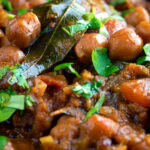 Close up vegan Punjabi chole masala curry or chana masala featuring a title overlay.