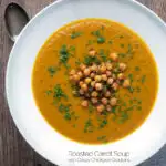 Overhead vegan roasted carrot soup with crispy chickpeas featuring a tittle overlay.