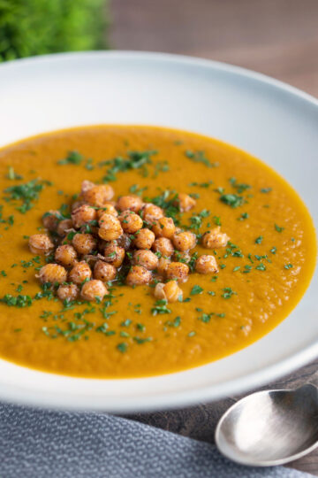 Spicy vegan roasted carrot soup with crispy chickpeas.