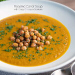 Spicy vegan roasted carrot soup with crispy chickpeas featuring a tittle overlay.