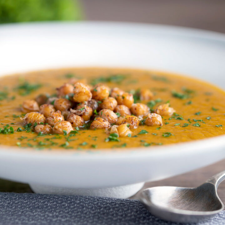 Spicy vegan roasted carrot soup with crispy chickpea croutons.