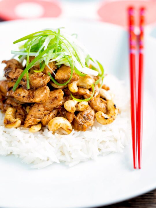 Szechuan chicken with cashew nuts and spring onion served on white rice.