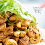 Close up Szechuan chicken with cashew nuts and spring onion served on white rice featuring a title overlay.