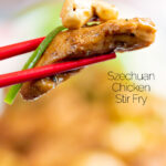 Close up Szechuan chicken with being held with chopsticks featuring a title overlay.