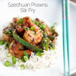 Szechuan prawns with green pepper served on steamed rice in a white bowl featuring a title overlay.
