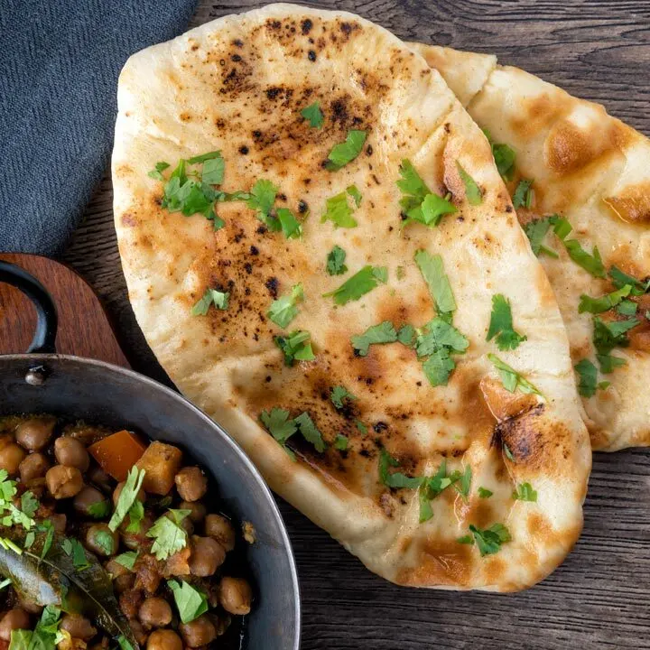 Overhead British Indian Curry house style Tandoori naan bread with coriander and ghee.