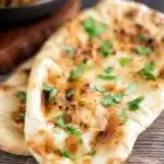 British Curry house style Tandoori naan bread with ghee and coriander.