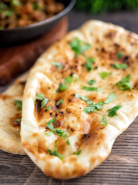 British Curry house style Tandoori naan bread with ghee and coriander.