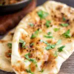 British Curry house style Tandoori naan bread with ghee and coriander featuring a title overlay.