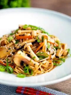 Vegetarian mushroom chow mein noodles served with shredded spring onion.