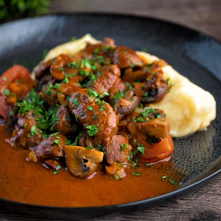 Wild boar stew with mushrooms served with mashed potato.