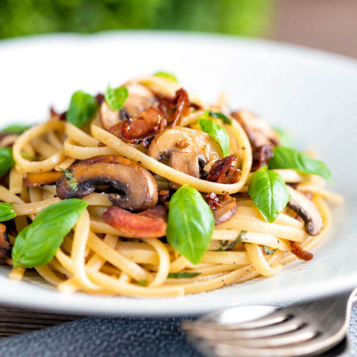 Bacon and mushroom pasta with sun dried tomatoes and fresh basil.