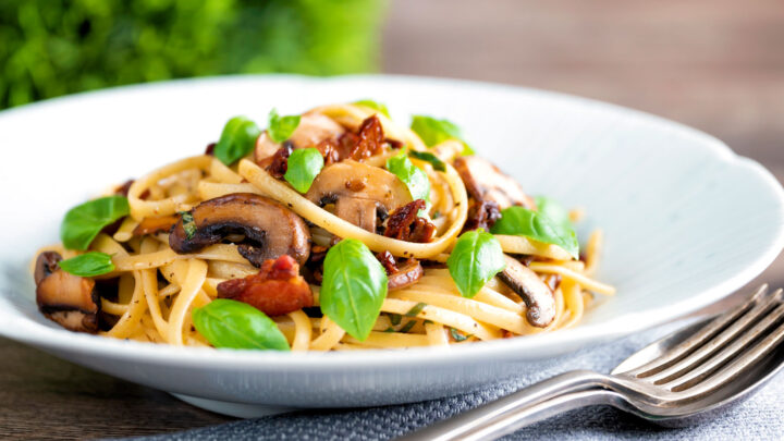 Bacon and mushroom pasta with sun dried tomatoes and fresh basil.