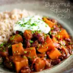 Butternut squash chilli served with brown rice, and sour cream featuring a title overlay.