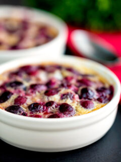 Individual cherry clafoutis desserts served in brulée pots.