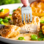Garlic lemon chicken breast cut open to show the moist perfectly cooked meat.