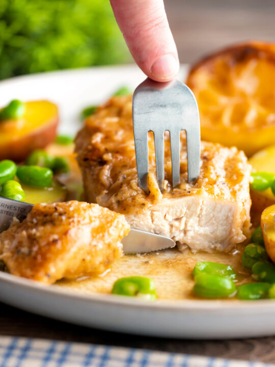 Garlic lemon chicken breast cut open to show the moist perfectly cooked meat.