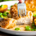 Garlic lemon chicken breast cut open to show the moist perfectly cooked meat featuring a title overlay.